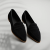 Pair of black suede pointed-toe loafers with tan outsole