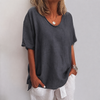 Woman wearing a dark gray oversized round neck top