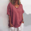 Woman wearing a dark pink oversized round neck top