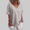 Woman wearing a gray oversized round neck top
