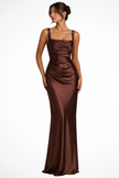 Woman wearing a brown satin evening gown with a ruched bodice