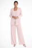 Woman wearing a light pink sequin jacket, camisole, and wide-leg trouser three piece set