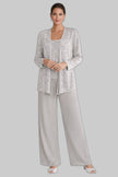 Woman wearing a silver sequin jacket, camisole, and wide-leg trouser three piece set