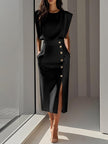 Model wearing black sleeveless midi dress with padded shoulders, gold side buttons, and front slit