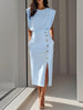 Woman in light blue sleeveless midi dress with structured shoulders and decorative gold buttons down the side