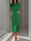 Model wearing vibrant green sleeveless midi dress with padded shoulders and gold side button detailing