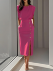 Model in hot pink fuchsia sleeveless midi dress with padded shoulders and decorative gold side buttons