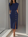 Woman in navy dark blue sleeveless midi dress with padded shoulders and gold side button detail