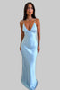 Woman wearing a light blue satin slip dress with thin straps and a V-neckline