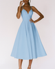 Woman wearing a light blue V-neck midi dress with spaghetti straps