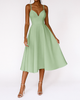 Woman wearing a sage green V-neck midi dress with spaghetti straps
