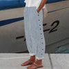 Light blue striped wide-leg pants with side button placket, side view