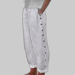 Off white striped wide-leg pants with side button placket, side view