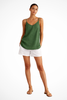 Woman wearing a green linen spaghetti strap top with white shorts
