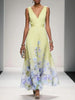 Women's V-Neck Floral Dress Maxi in Yellow — full length runway view with soft purple and blue floral border hem