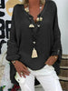 Woman wearing a black oversized V-neck top