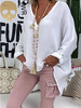 Woman wearing a white oversized V-neck top