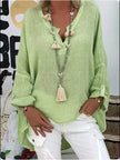 Woman wearing a green oversized V-neck top