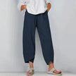 Model in navy blue wide leg casual pants with unique cropped asymmetric hem and drawstring waist