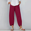 Woman wearing wine red wide leg casual pants with overlapping cropped hem and side pockets