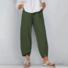 Model in olive green wide leg casual pants with asymmetric cropped hemline, styled with white shirt